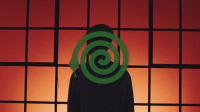 Green animated snake making a spiral on top of a background with a man's silhouette