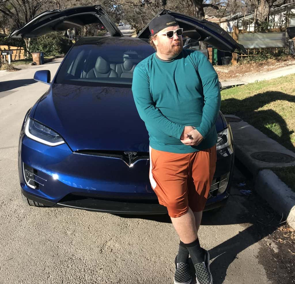 Jason in front of his new Tesla.