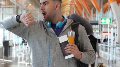 A guy in the airport looking shocked.