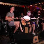 101X-Session With AJR: The guys from AJR singing into microphones at Spiderhouse Ballroom