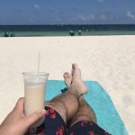 Nick In Mexico: nick reclining on the beach with his feet up and a pina colada in his hand