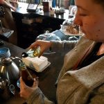 Pouring Syrup From A Topo Chico Bottle Into Coffee In A Topo Chico Bottle