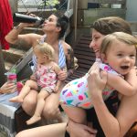 Babies And Deb: Deb drinking a water bottle and Babies around