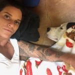 After Blue's Doggy Acupuncture: Image of Deb's dog blue with a blanket over his head as he is sleeping next to Deb. 