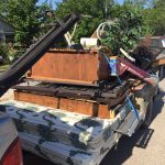 Trash Day In Granger, Texas: An old trailer loaded to probably unsafe levels with things to throw away