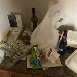 Jason's Vegas Vacation: a bunch of money, booze bottles, and old food containers left on Jason's hotel nightstand