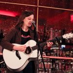 101X-Session Featuring UKTX Artist Jade Bird: Jade Bird strumming guitar