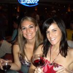 #TBT Bud Light Party Cruise : Deb and former ‘Sorority Intern’ Cassandra at the Bahamas Bud Light Party Cruise from 2009 holding a glass of wine in front of a Bud Light sign. 