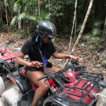Producer Imari's Trip To Cancun: Producer Imari driving a four wheel car in the woods in Mexico. 