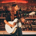 101X-Session Featuring UKTX Artist Jade Bird: Jade Bird strumming guitar and singing