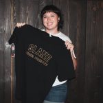 101X Homegrown Live Presents Pennyfest 2019: Woman holding a Slane Irish Whiskey shirt
