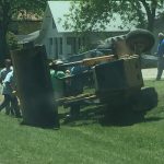 Trash Day In Granger, Texas: an overturned backhoe loader resting in a ditch