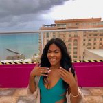 Producer Imari's Trip To Cancun : Producer Imari at a hotel rooftop pool in front of the beach. 