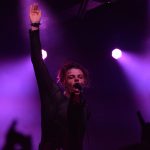 101X Concert Series Featuring YUNGBLUD: YUNGBLUD singing into a microphone with his arm up