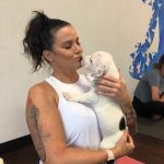 Puppy Yoga : Deb kissing a puppy at puppy yoga. 