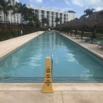 Nick In Mexico: a long swimming pool with a wet floor sign in front of it