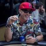 Beat The Dick Poker Tournament : A poker player wearing a sunglasses at the poker table and with a Bud Light