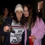 Merry Christmas Ya Filthy Animals: Deb and her friend holding drinks at Deb