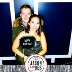 Jason & Deb's Don't Go Downtown NYE Party: couple posing holding a prop
