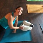 Puppy Yoga : A lady doing puppy yoga on a mat. 
