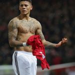 Marcos Rojo: Argentina Defender: Marcos Rojo: Argentina defender with his shirt off holding jersey in hand during a game 