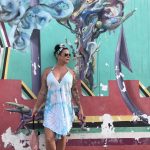 Deb's Vacation To Isla Mujeres: Deb in Mexico on vacation in front of a painted wall. 