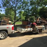 Trash Day In Granger, Texas: A trailer with mattresses and other garbage stacked on top of the hitch
