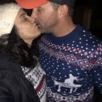 Hot Toddy Kisses: Deb and SA guy kissing in ugly Christmas sweaters. 