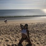Bali Beach Shoot Rear View: Deb on a black and white bathing suit on a beach in Bali 