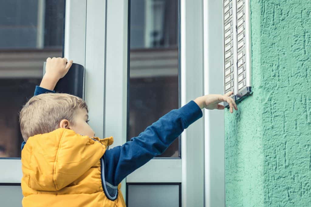 A kid ringing doorbell and knocking door.