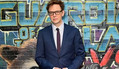 James Gunn in front of Guardians of the Galaxy poster