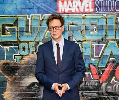 James Gunn in front of Guardians of the Galaxy poster