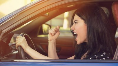 A lady in her car upset.