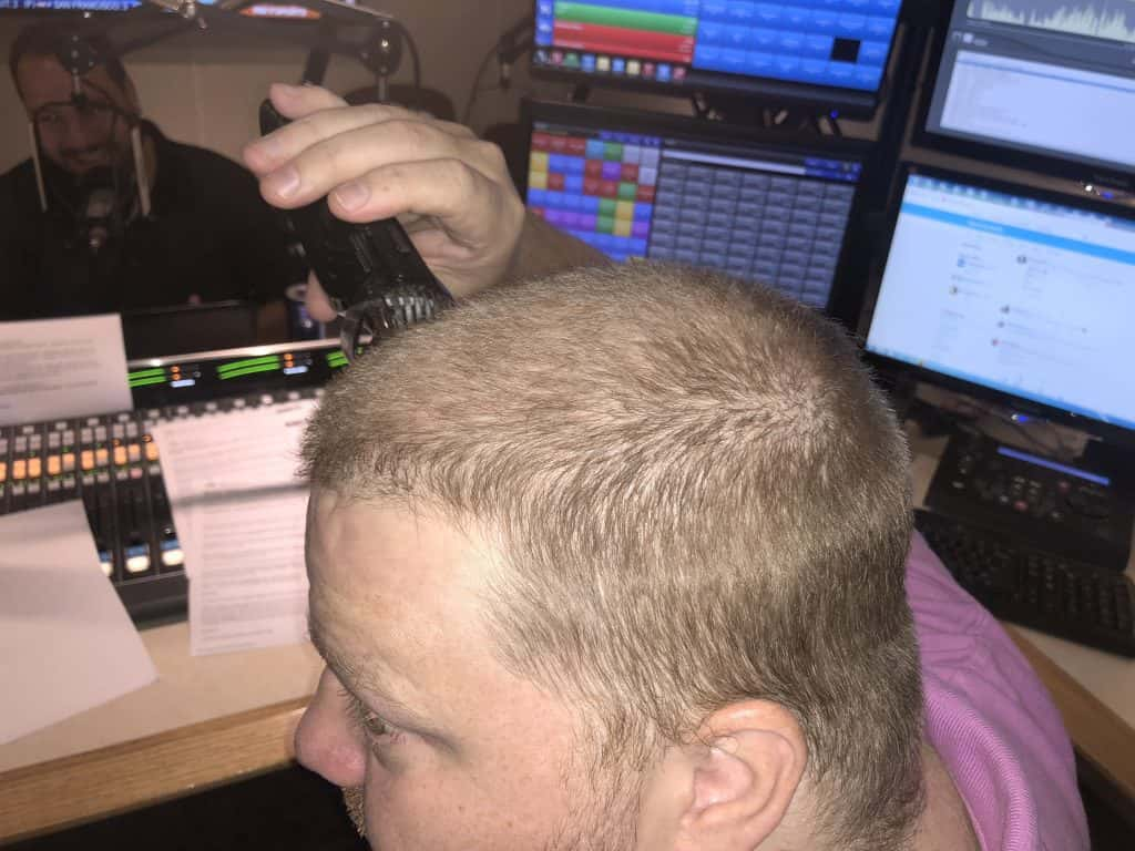 Image of Jason shaving his head in the studio