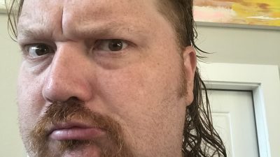 Jason showing off his new mullet haircut and mustache