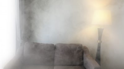 Sofa and lamp in smoke. Black and white in The house is mysterious and old.