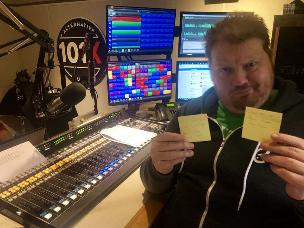 Jason holding up sticky notes in the studio.