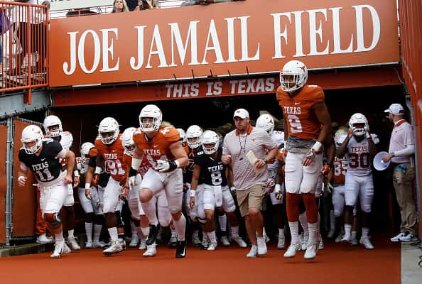 Head coach Tom Herman of the Texas Longhorns leads the team out of the tunnel before the Orange-White Spring Game at Darrell K R