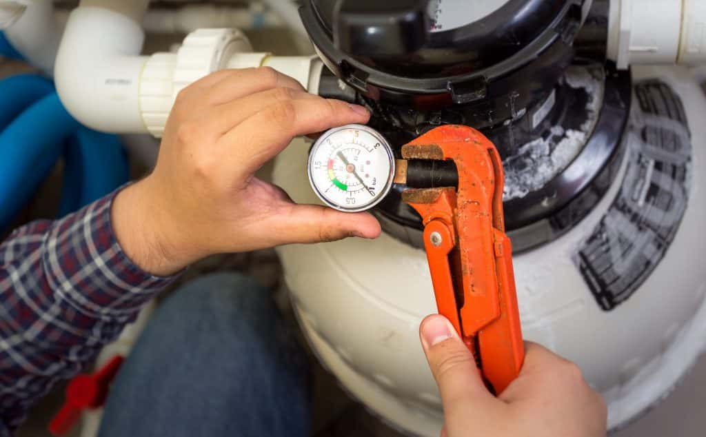 Gas repair man cutting off gas with orange pliers