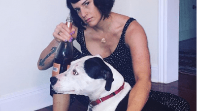 Deb with Blue and a bottle of wine.