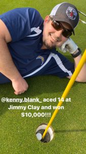 Kenny laying by his hole in one 