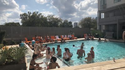 People in the pool withe sunshine in the background