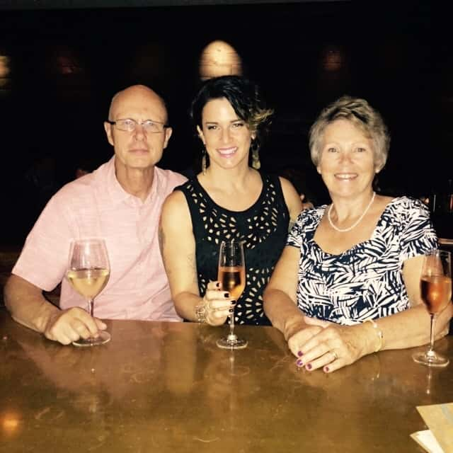 Deb drinking wine with her mum and father-in-law on her birthday