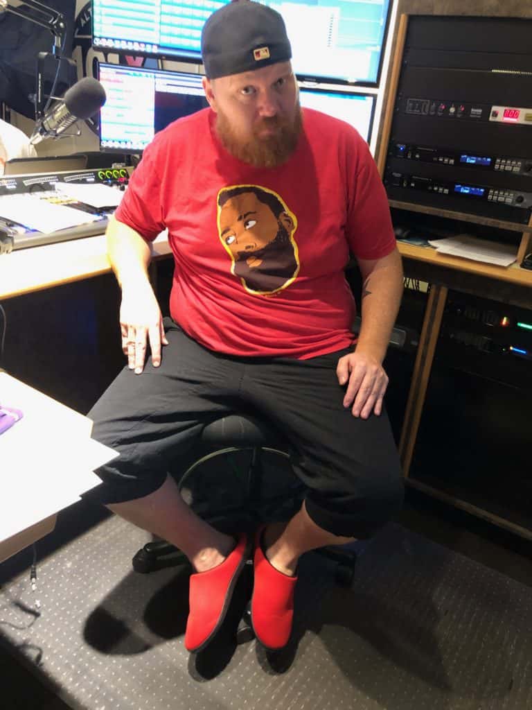 jason in studio showing off his new bright red house shoes