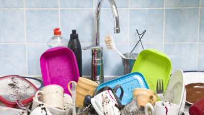 a stock photo of a bunch of dirty dishes piled in a sink