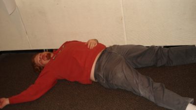 jason dick lying down on the studio floor with a blank look in his eyes