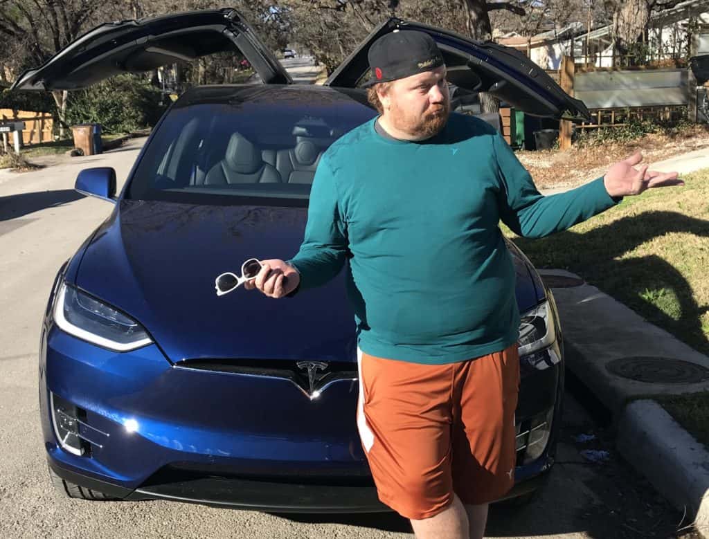 jason posing in front of his then-new tesla