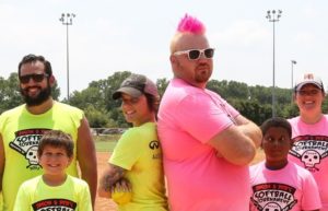 jason and deb posing back to back at our softball tournament
