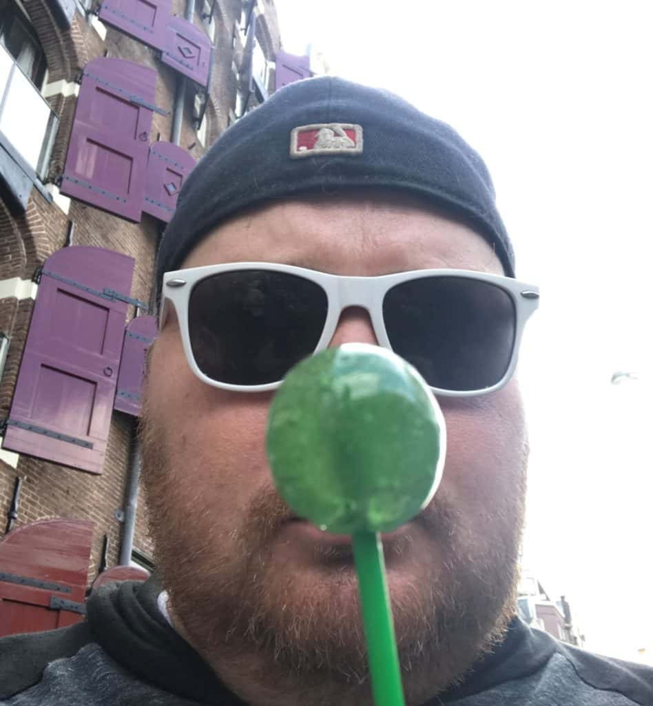 Jason holding a CBD infused lollipop in Amsterdam