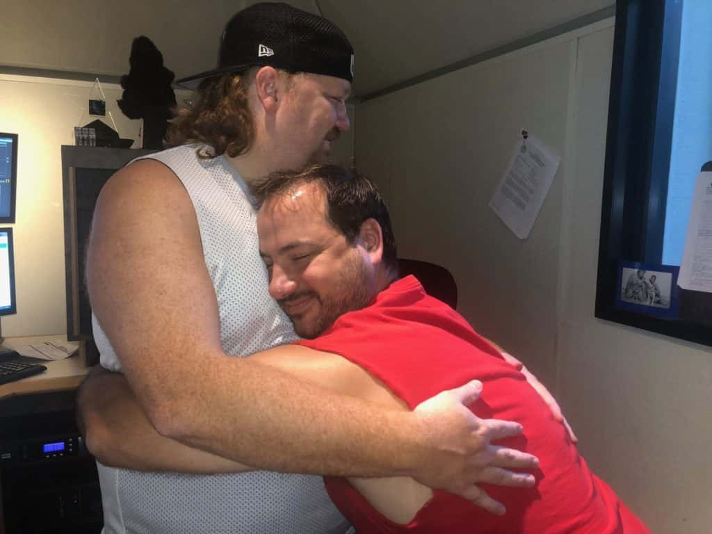 Nick and Jason having a solid bro hug in the studio